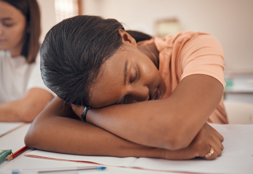 Girl, teenager or classroom sleeping in stress, depression or mental health burnout in Indian educa