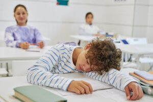 Teen Boy Sleeping in School
