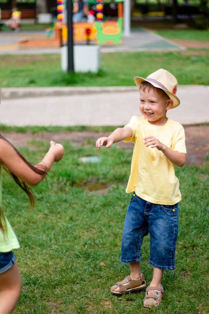 happy child playing in the street. The child laughs and plays.