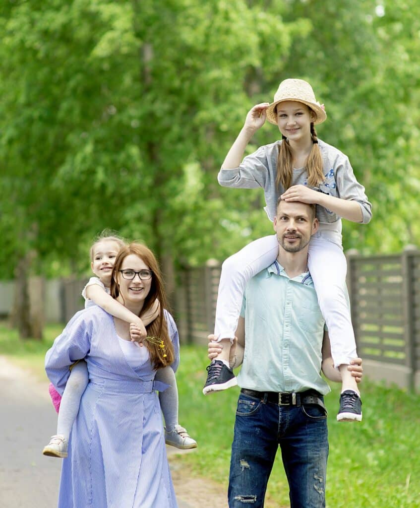 Happy family-mother,father and two children daughter little girl teen having fun outdoor