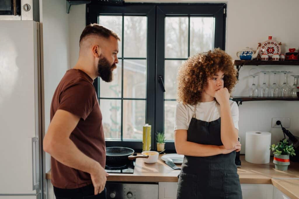 Young couple arguing in kitchen after having a fight