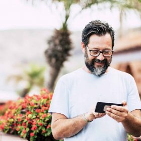 Happy adult man with beard and glasses